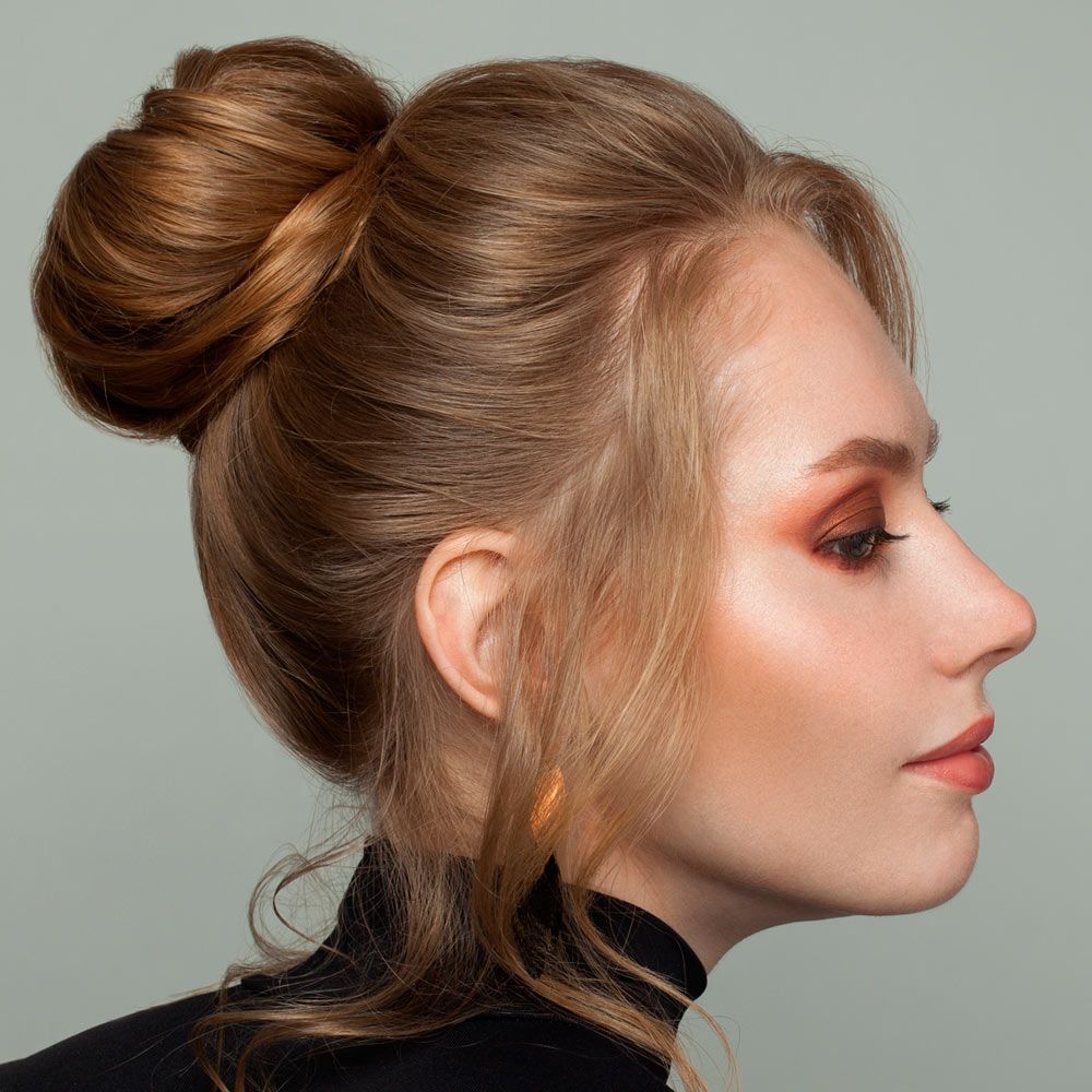 Top Bun Hairstyle With Side Bangs