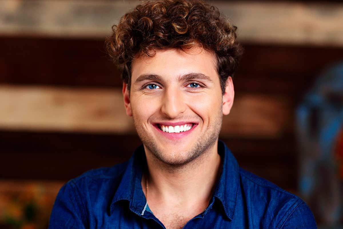 dark brown curly hair guy