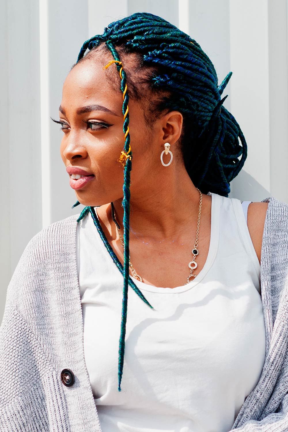 Blue Dreads Styled Into Low Bun