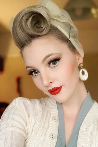 Beautiful young woman with hair in victory rolls from 1940s holding a  camera Stock Photo  Alamy