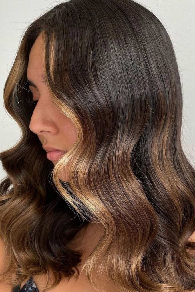 With this sexy style, you can opt for thicker stripes of a warm cinnamon to your brunette roots