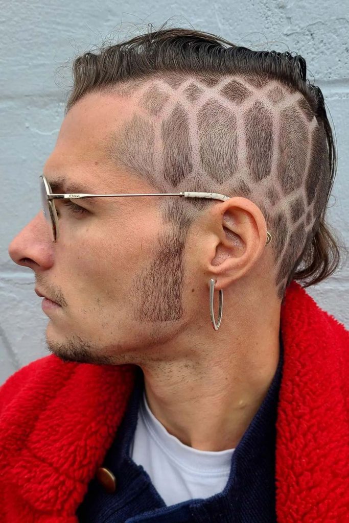 To take your faded mohawk haircut to the next level of uniqueness and coolness, we suggest you experiment with stylish tattoo ideas implemented into the shaved sides.