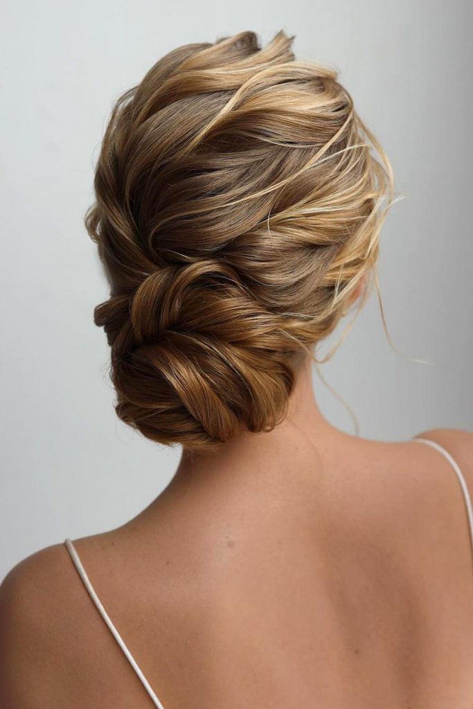 A classic low bun or loose and romantic bun never go out of style, that's why they are ideal for prom hair