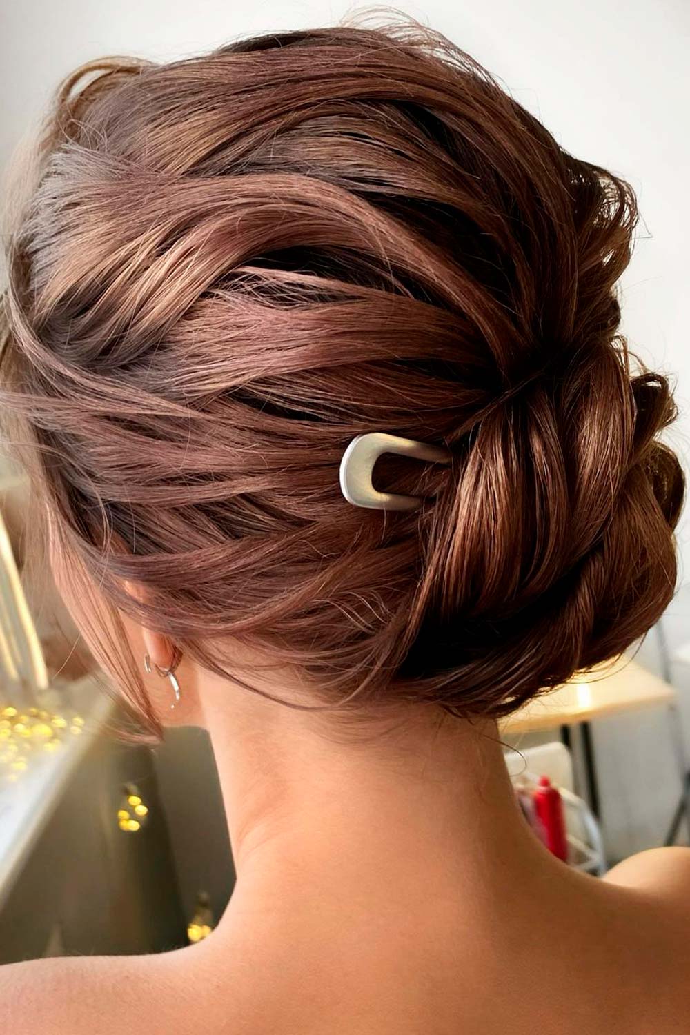 A loose updo with some accessory is a classic choice