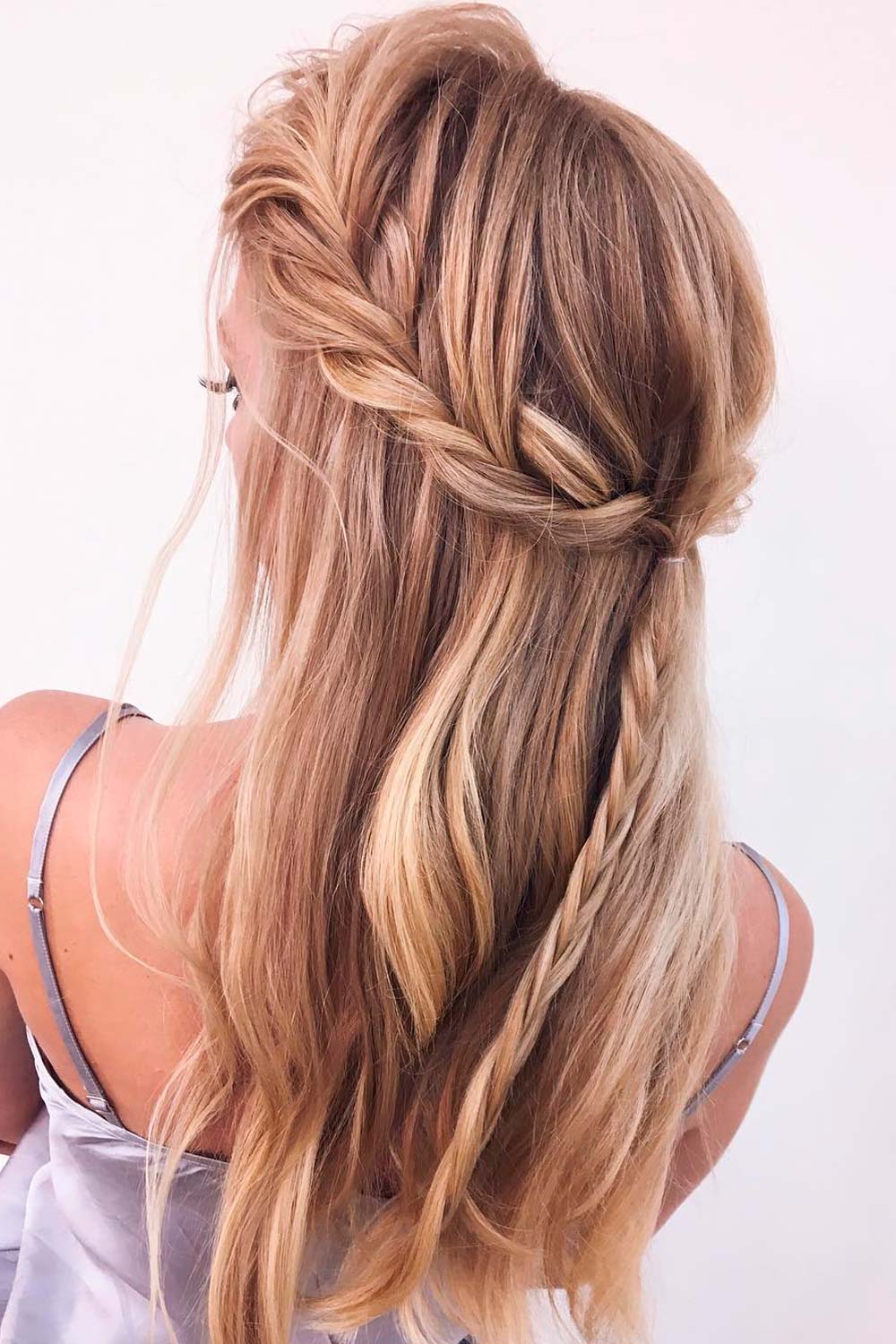 A top knot and a waterfall braid are some of the best examples of half up half down hairstyles for Christmas