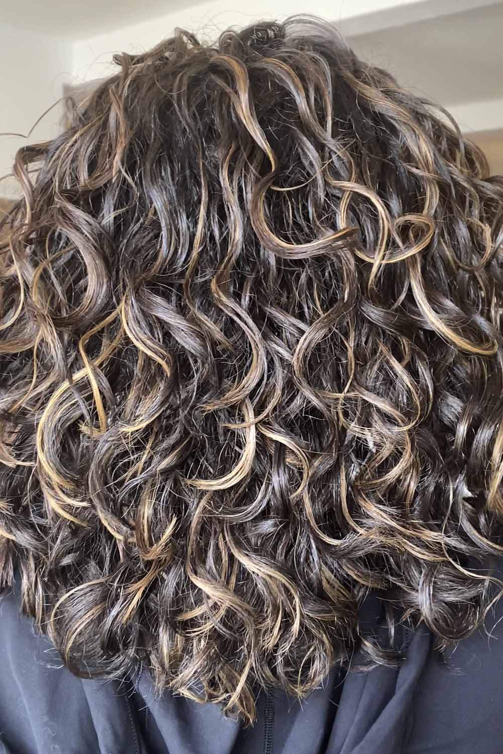 Choose to balayage your curly hair when you desire low-maintenance, lived-in color