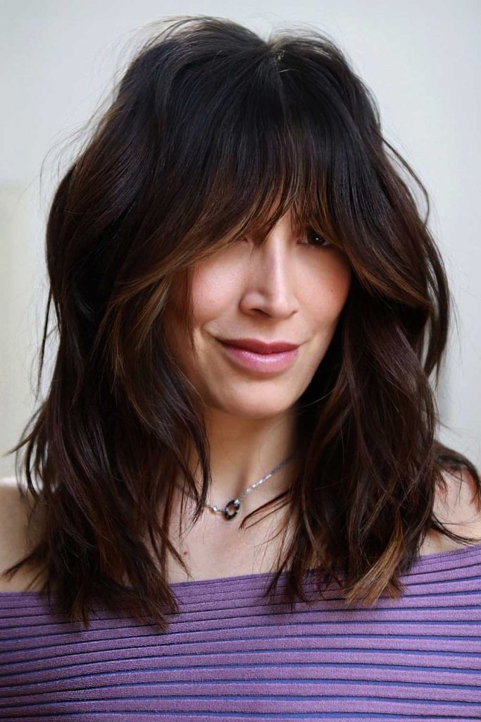Highlighted Curtain Bangs with Wavy Layered Hair